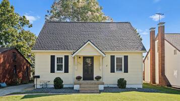A single-story house with a gabled roof, a front porch, and a mailbox.
