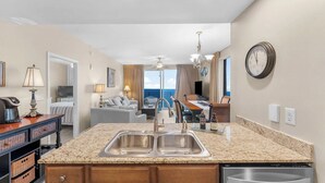 A kitchen with a granite countertop, stainless steel sink, and a dishwasher. - Spacious 3BR/3BA Splash Condo & Amazing Gulf Views — Free Beach Chairs Included! (Panama City Beach)