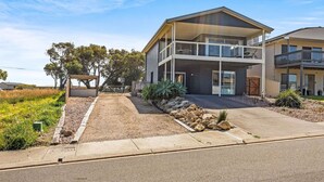 A modern two-story house with a covered patio, a basketball court, and a landscaped front yard. - Wave Riders in Goolwa Beach (Goolwa Beach)