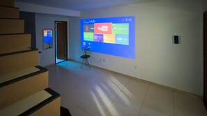A hallway with a large screen displaying various streaming services. - casa 4 (Saquarema)