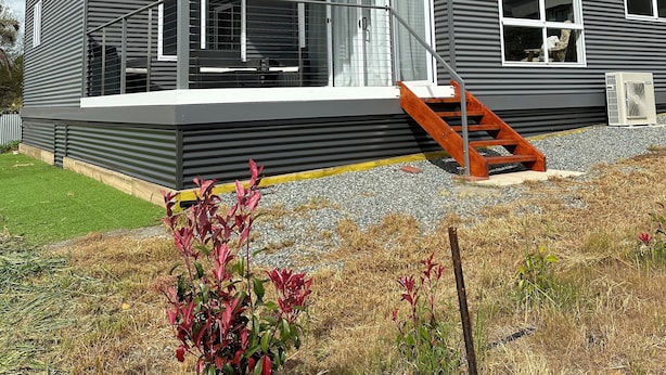 A modern two-story house with a covered porch, large windows, and a staircase leading to the upper level. - Cosy and comfortable executive Unit with gorgeous views and close to town centre (Clare)