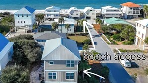 A coastal residential area with houses and a road leading to the beach. - Luxurious home with a Gulf View 4-bedroom with a Private Pool on Cape San Blas (Port St. Joe)