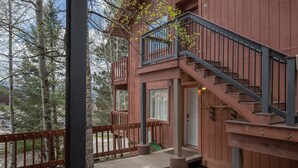 A wooden cabin with a staircase leading to a balcony, surrounded by trees. - 3-Min Walk to Ski Lift | Mountain-View Chalet (Angel Fire)