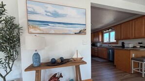 Een moderne keuken met houten kastjes, een centraal eiland en uitzicht op de eetruimte.
