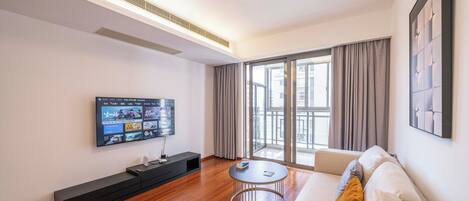 Superior Apartment, 2 Bedrooms, City View | Living room | 55-inch Smart TV with cable channels