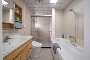 A bathroom with a toilet, sink, bathtub, shower, and a mirror. - Tyms Family 4BR 2BA APT Residence (Shanghai)