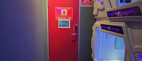 A red door with a sign indicating women-only rooms, numbered 051 to 058.