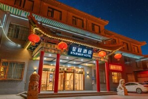 A traditional building with a sign for Starway Hotel, featuring a classic architectural style with red lanterns and a decorative roof. - Starway Hotel (Wutai Mountain) (Wutai)