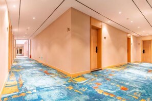 A hotel corridor with carpeted flooring, doors, and a hallway leading to another room. - Starway Hotel (Wutai Mountain) (Wutai)