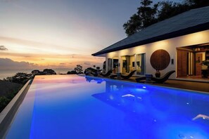 A modern house with a swimming pool, a well-lit exterior, and a view of the sky. - MM Villa Koh Samui 8-Bedroom Seaview Sunset Estate with 2 Pools (Koh Samui)