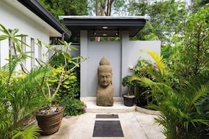 A serene garden with a Buddha statue, potted plants, and a pathway. - MM Villa Koh Samui 8-Bedroom Seaview Sunset Estate with 2 Pools (Koh Samui)