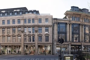 A historic building with multiple storefronts, including a hotel named 'The Glutton.' - The Store (Oxford)