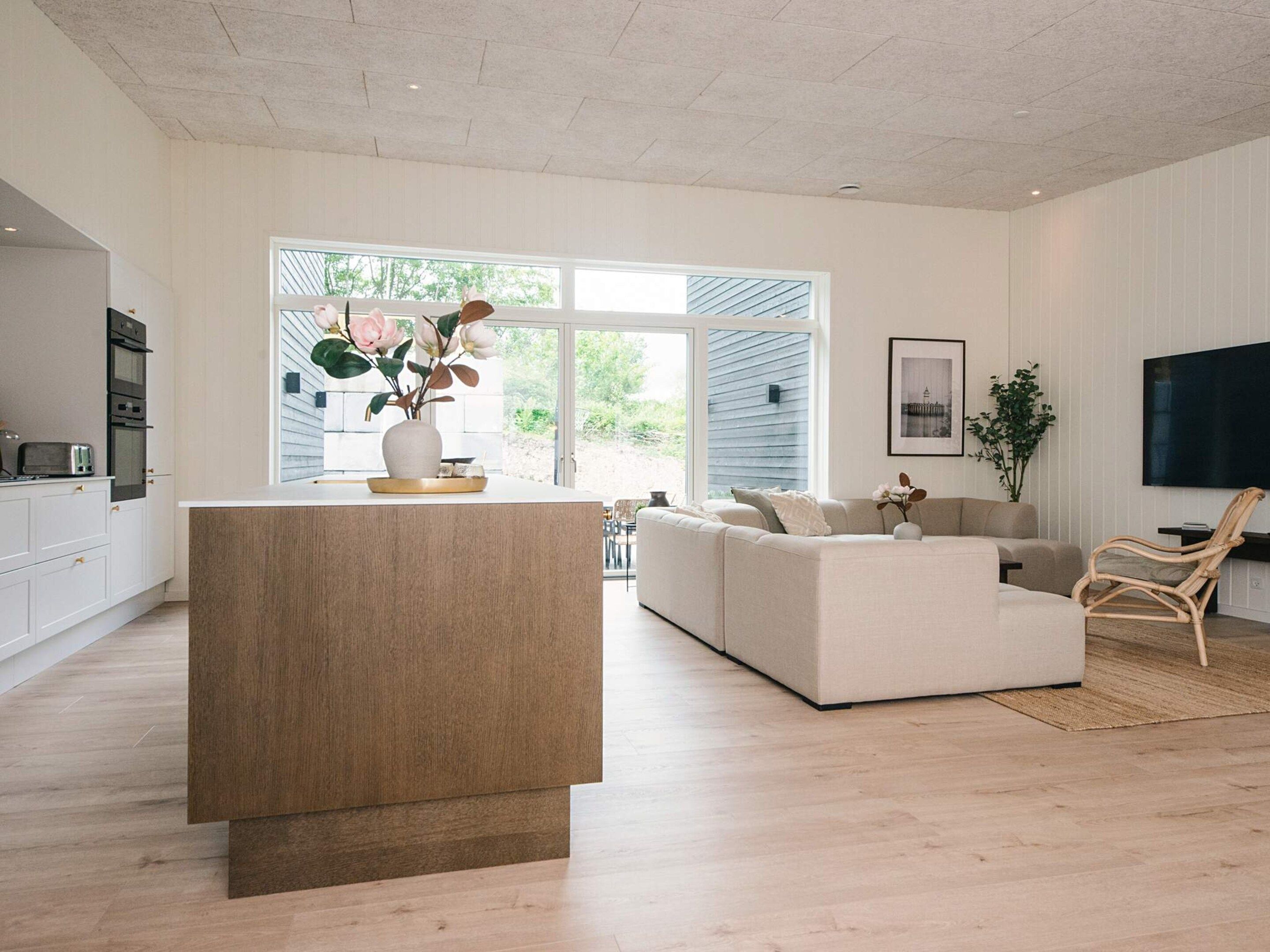 A modern living room with a sofa, a coffee table, and a TV.