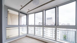 A high-rise apartment with large windows offering views of the cityscape. - Tyms Spacious 3BR 2BA APT  Laishi Di (Shanghai)