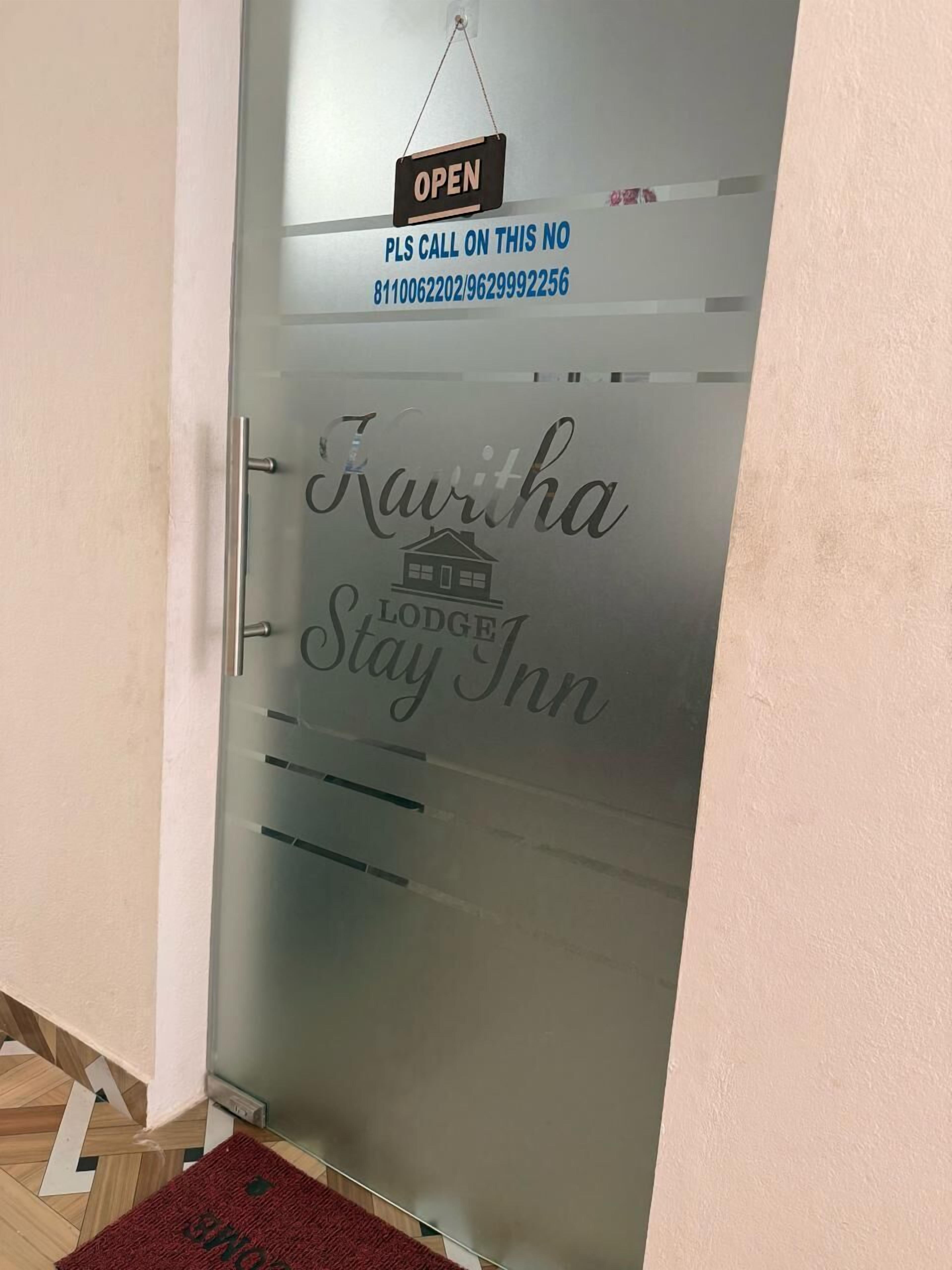 A frosted glass door with the name "Kavitha Lodge Stay Inn" and a phone number for inquiries.