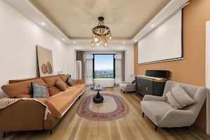 A modern living room with a sofa, armchair, and a coffee table. - My Heart Returns · Zhangjiajie Zero-Pressure Luxury Dream Apartment (Zhangjiajie)