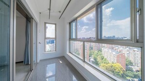 A high-rise apartment with large windows offering city views. - Tyms Xintiandi Elegant 3BR 2BA APT  (Shanghai)