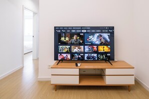 Superior Apartment, Balcony, City View | Living room | 55-inch Smart TV with cable channels