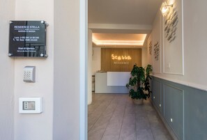 A reception area with a sign for 'Residence Stella' and a reception desk. - Residence Stella (Massa)