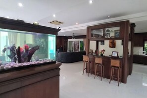 A modern interior with a reception desk, bar area, and seating. - ViewPoint Villa (Phuket)