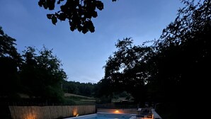 A wooden deck surrounding a swimming pool with built-in lighting. - Miramonde, romantic holiday home (Savignac-de-Miremont)