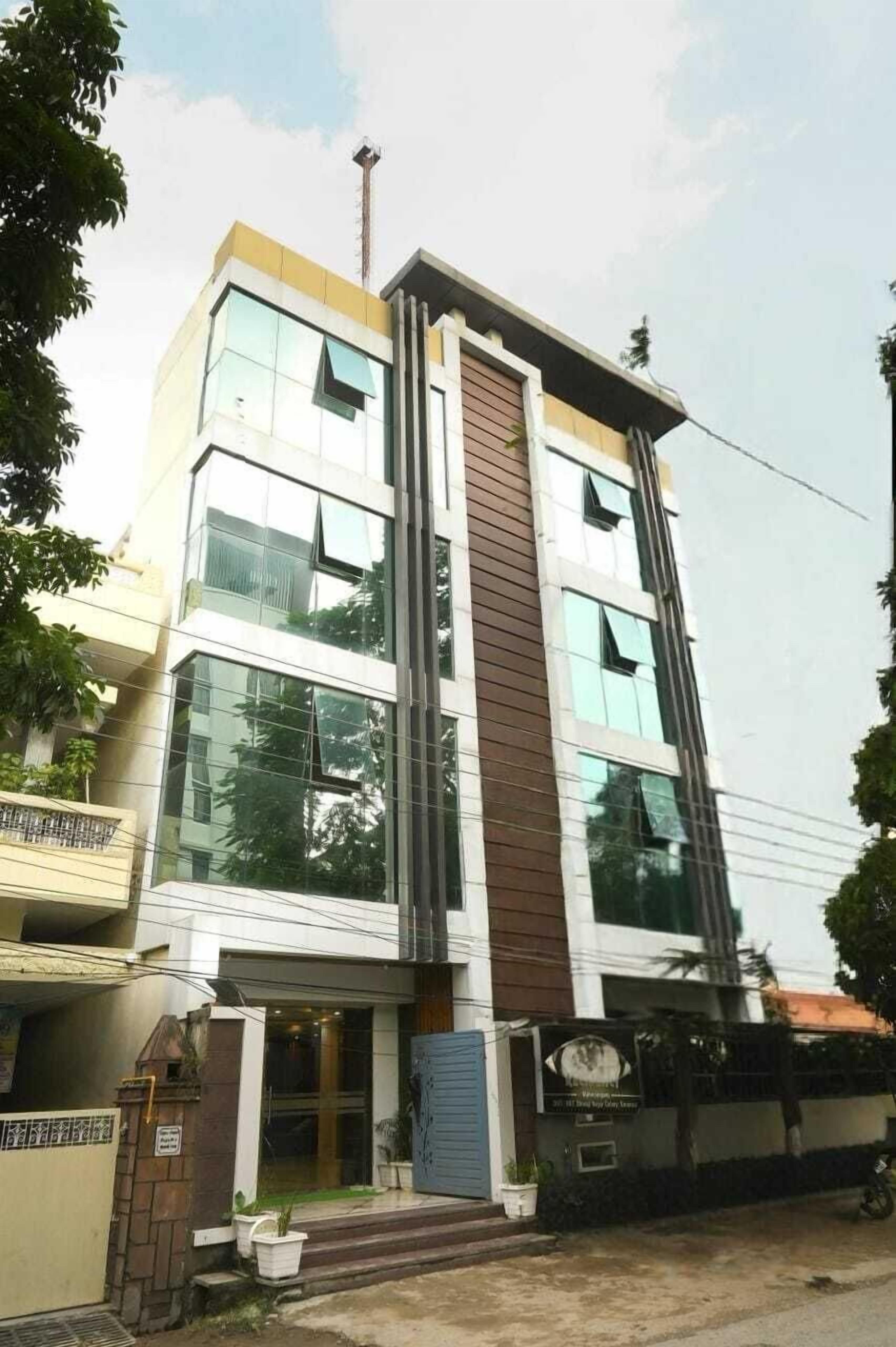 A multi-story building with a modern architectural design, featuring large windows and a prominent vertical element.