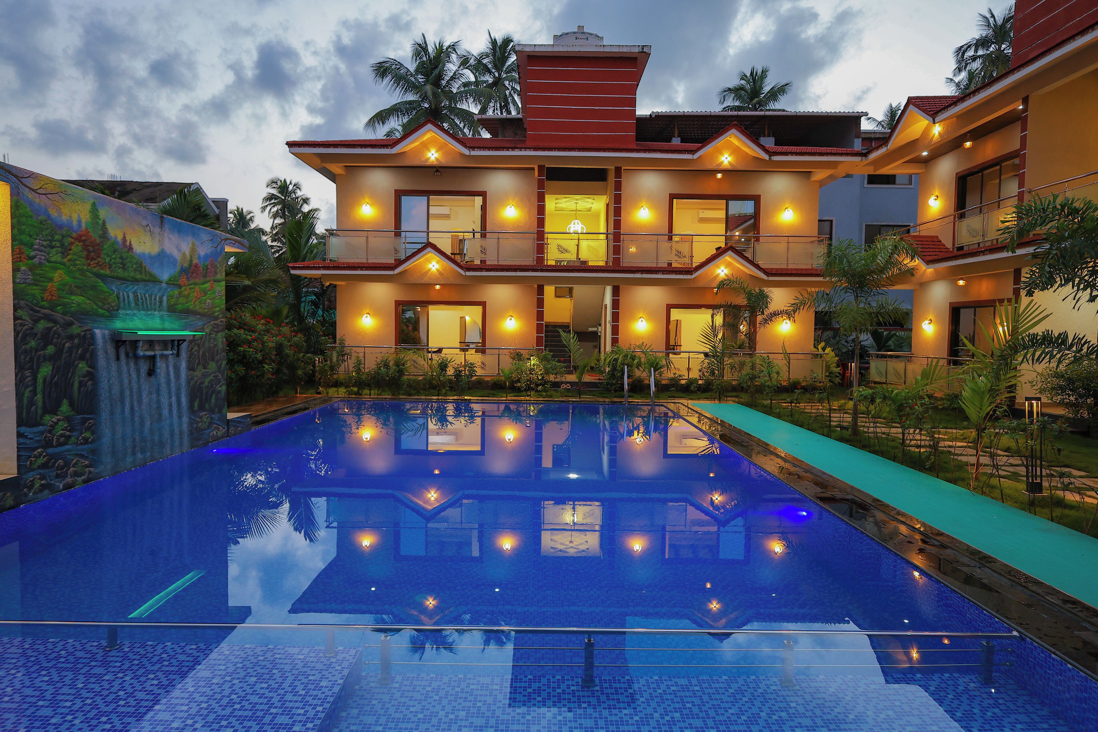 A two-story building with a swimming pool in front.