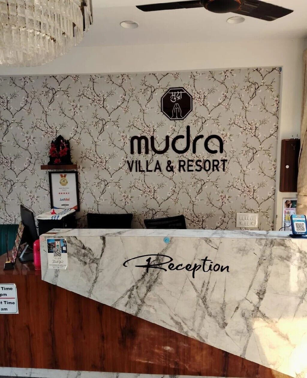 A reception desk with a marble top labeled 'Reception' at Mudra Villa & Resort.