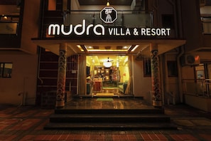 The entrance of Mudra Villa & Resort with a sign above the door and a staircase leading inside. - Mudra Villa & Resort (Nagaon)