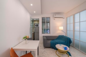 Apartamento superior, 1 quarto, micro-ondas, vista para a cidade | Sala de estar | Smart TV 55 polegadas com canais a cabo