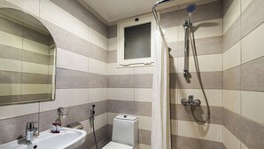 A modern bathroom with a sink, toilet, and shower. - Razana Al Hafayyer (Makkah)