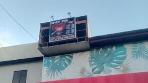 A Honda dealership with a red and white color scheme, a large Honda logo, and a billboard above the entrance advertising a new car model. - WJV INN JUGAN (Liloan)