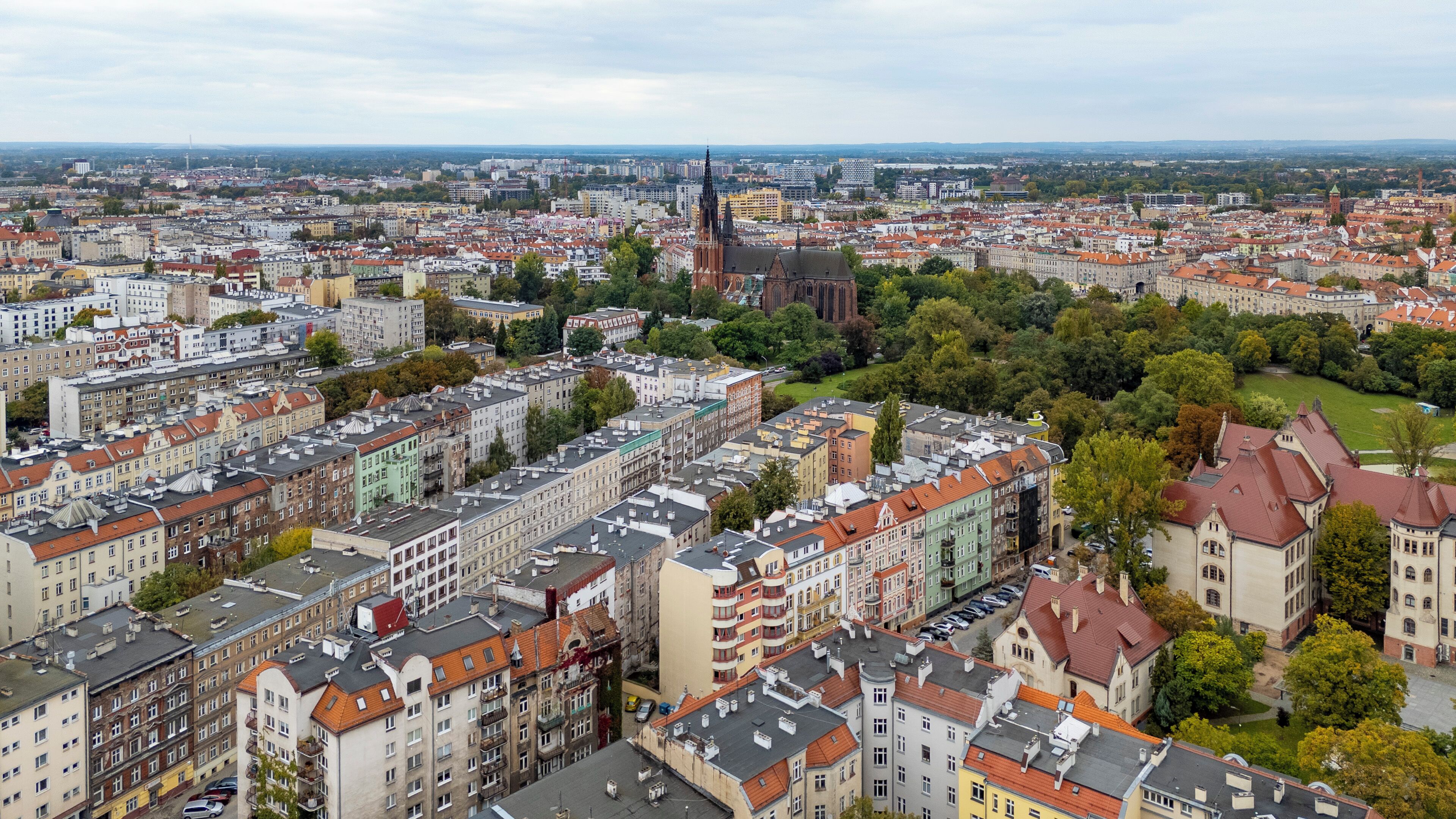 A cityscape with a prominent church and dense residential buildings.