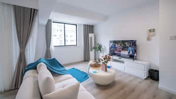 Superior Apartment, 2 Bedrooms, City View | Living room | 55-inch Smart TV with cable channels
