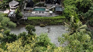 A large resort with multiple buildings, a swimming pool, and lush greenery. - Lawangkala Resort Ubud (Ubud)