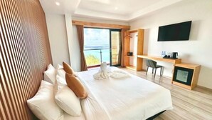 A modern hotel room with a large bed, a desk, a flat-screen TV, and a balcony with a view. - AIMI Beach, Gulhi Island, Maldives (Gulhi)