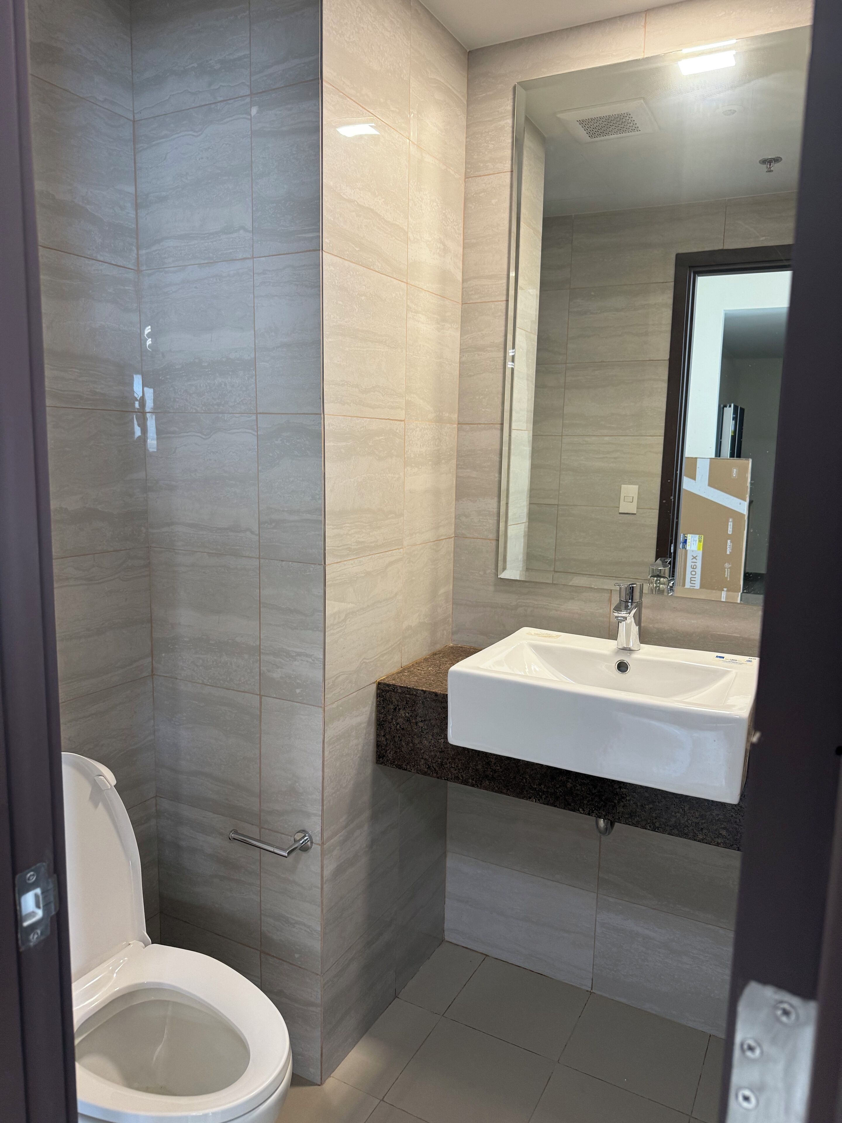 Un bany modern amb vàter, un lavabo i una zona de dutxa.