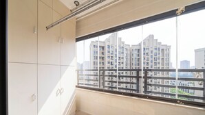 A room with a large window, a sliding door, and a view of high-rise buildings. - Tyms 2BR APT Xujiahui Dacheng Residence (Shanghai)
