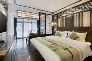 A modern hotel room with a large bed, a TV, and a view of the outdoors. - Floral Hotel ·Fenghuang Grand Riverview (Fenghuang)