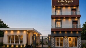 Un hôtel moderne avec une enseigne bien visible indiquant « Radhe Shyam Resort ».
