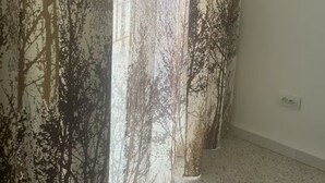 A room with a large window, a white wall, and a visible electrical outlet. - Urban Oasis in Algiers' Heart (Sidi M'Hamed)