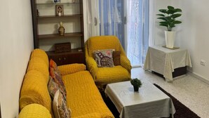 A living room with a sofa set, a small table, a bookshelf, and a potted plant. - Urban Oasis in Algiers' Heart (Sidi M'Hamed)