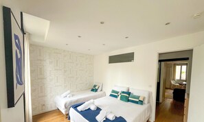A modern hotel room with two beds, a geometric patterned wall, and a view to a balcony. - Urban Flat 04 - Pretty 2 Bedroom Flat in Montorgueil (París)