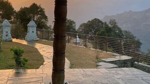 A stone pillar, a stone path, and a small shrine in a mountainous area. - Experience luxury in this stunning villa with views and a private chef (Tanchowk village)