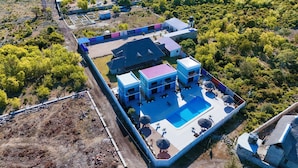 An aerial view of a modern hotel with a swimming pool, multiple buildings, and a surrounding natural landscape. - Wayma Paradise Resort (Marumbi)