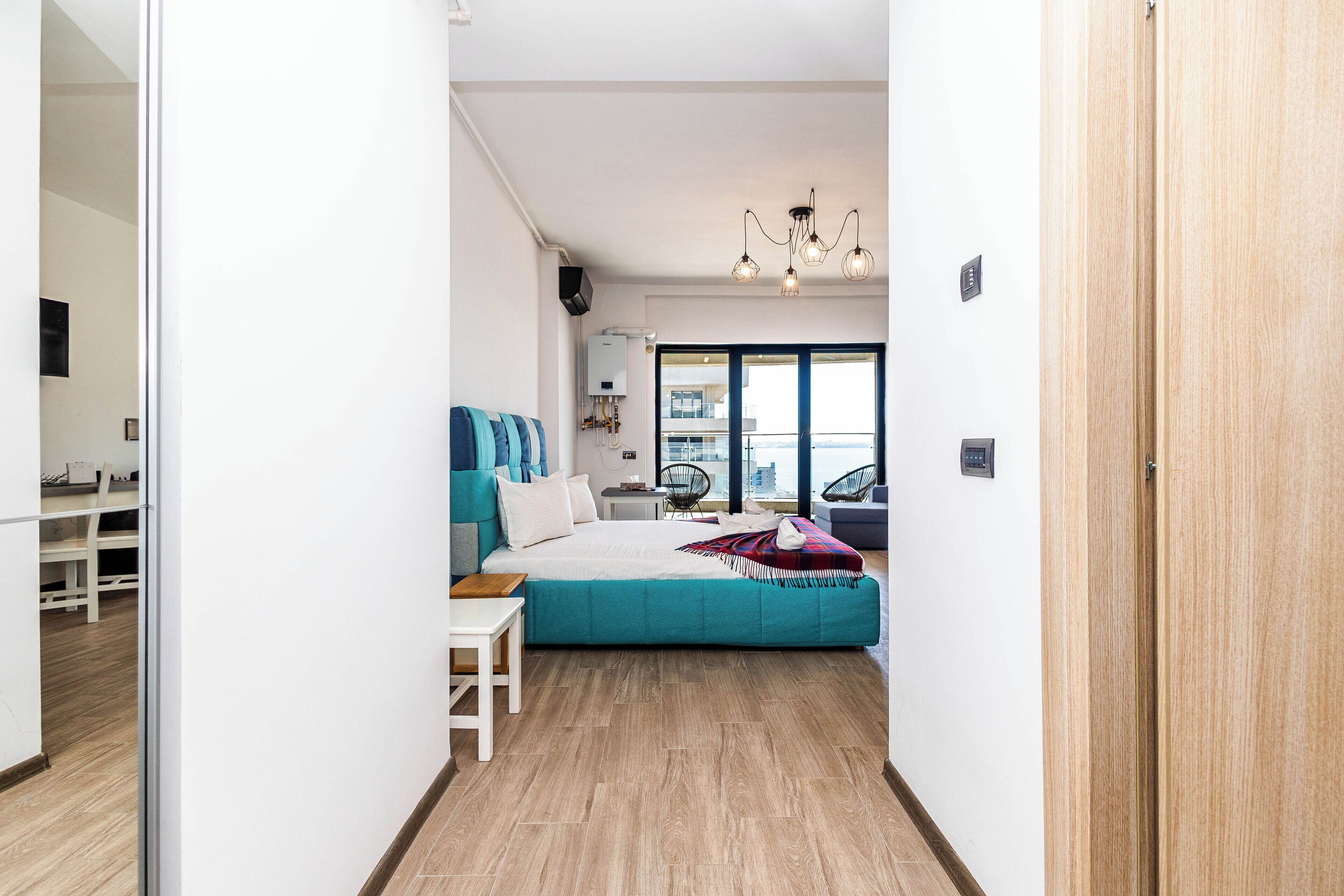 Une chambre moderne avec un grand lit, un bureau et une vue sur la ville.