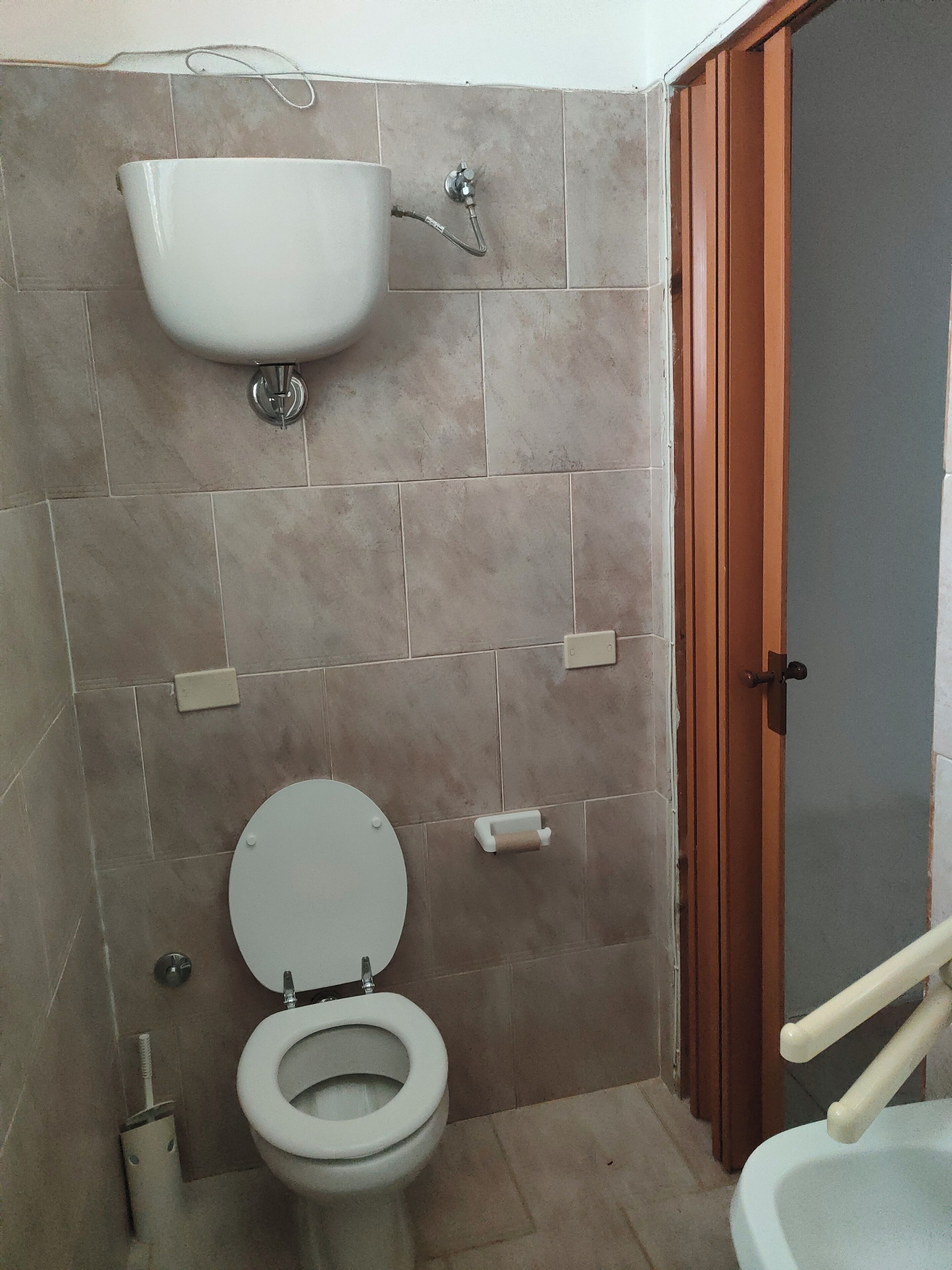 A bathroom with a toilet, a sink, and a shower.
