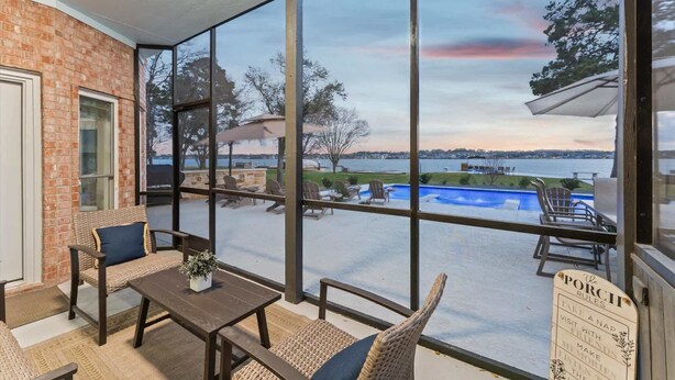 A covered patio with a view of a lake, outdoor furniture, and a sign with rules. - Lake it easy, Fish, Kayak, Yard, Boat, Sleeps 20 (Montgomery)