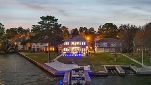 A waterfront property with a dock, a swimming pool, and a house with large windows. - Lake it easy, Fish, Kayak, Yard, Boat, Sleeps 20 (Montgomery)