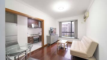 Superior Apartment, 1 Bedroom, Kitchen, City View | Living room | 55-inch Smart TV with cable channels
